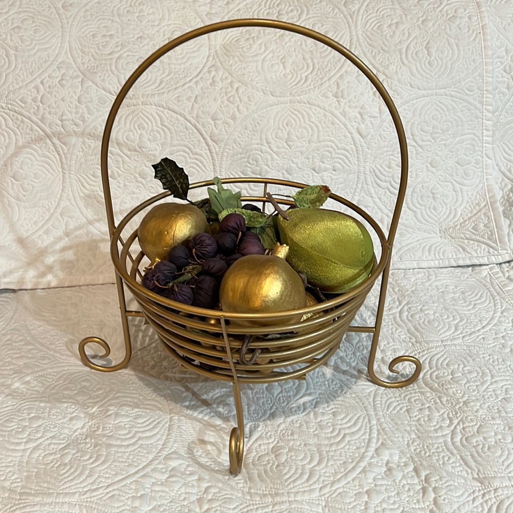 Golden basket with faux‎ fruit